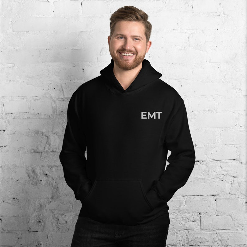 May include: Black hooded sweatshirt with the word "EMT" embroidered on the front in white.