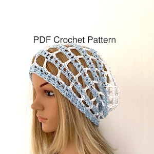 May include: A light blue and white crochet beanie hat. The hat is made with a simple stitch pattern and has a loose, slouchy fit. PDF Crochet Pattern.
