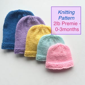 May include: Five knitted baby hats in blue, purple, yellow, teal, and pink. The hats are displayed in a row, highlighting their colours. The image includes text that reads "Knitting Pattern 2lb Premie - 0-3 months."