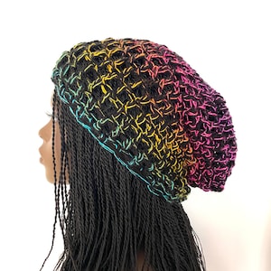 May include: A rainbow ombre crochet beanie hat with a black background. The hat is made with a loose, open stitch.
