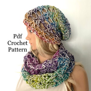 May include: A crocheted beanie and infinity scarf set in a rainbow of colors, including purple, green, blue, and yellow. The text "Pdf Crochet Pattern" is visible on the left side of the image. The set is displayed on a mannequin.