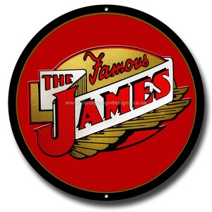 May include: A round, red metal sign with the words "The Famous JAMES" in a vintage style. The sign has a black border and gold accents, including wings. The text is in red, white, and gold.