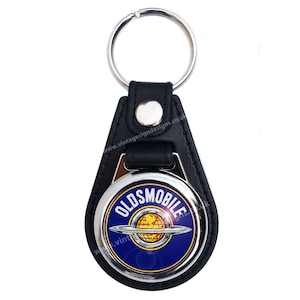 Oldsmobile round key ring / fob.