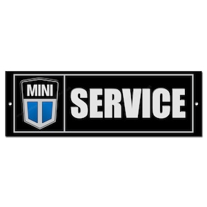 May include: A rectangular black sign with the word "SERVICE" in large white letters. The left side features a Mini logo with a blue and white shield. The sign has a white border and two mounting holes.