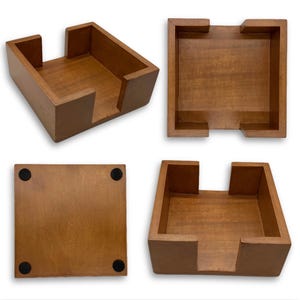 May include: A square wooden coaster holder with a medium brown finish. The holder features four high walls with cutouts on two sides for easy access. The underside of the base includes four small black circular pads at each corner for stability.