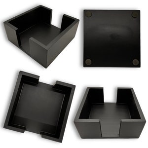 May include: Black square-shaped tissue box holder with a cutout on the top and four rubber feet on the bottom.