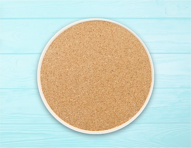 May include: A round cork coaster with a white rim. The coaster is made of natural cork and has a light brown colour.