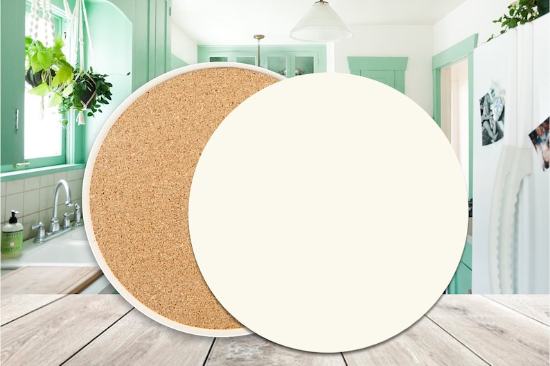 May include: A round, white ceramic coaster with a cork backing. The coaster is shown on a wooden surface.