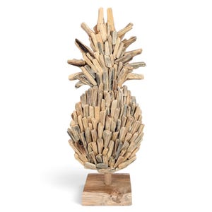 May include: A decorative pineapple sculpture constructed from numerous small, light-colored pieces of driftwood. The organic, textured wooden segments are arranged to form the fruit's body and leafy top, all mounted on a square wooden base.