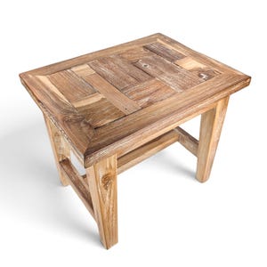 May include: A rectangular side table constructed from reclaimed wood with a natural brown finish. The tabletop features a mosaic pattern of small, interlocking wooden planks, supported by four sturdy, slightly tapered legs with crossbars.