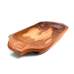 May include: An elongated, rectangular wooden bowl with rounded corners and integrated handles on each end. The bowl features a natural light and dark brown wood grain pattern with a smooth, polished finish and a deep, concave center basin.