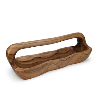 May include: A wooden serving bowl with a unique, carved handle. The bowl is made of natural wood with a rich brown color and a smooth, polished finish.
