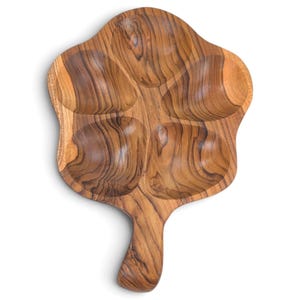 May include: A wooden serving tray shaped like a five-petaled flower with a handle at the base. The tray features a natural light and dark brown wood grain pattern with four distinct, rounded, concave sections for holding food items.