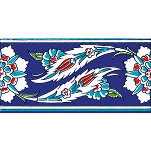 May include: A blue and white ceramic tile with a floral design. The tile features white flowers with red centers and green leaves on a blue background.
