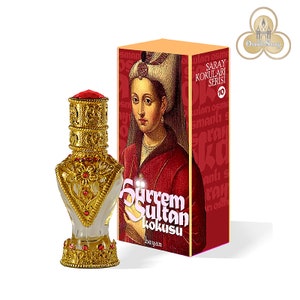 May include: A gold and red glass bottle with a decorative stopper. The bottle is labeled "Surrem Sultan kokusu bayan" and is part of the "Saray Kokuları Serisi" collection.