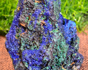 May include: Azurite and malachite specimen with a rough, textured surface. The blue and green colors are vibrant and contrasting. The specimen is a natural mineral.