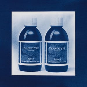 May include: Two dark blue bottles of Cyanotype sensitizer, Part A and Part B, each containing 250 ml of liquid. The labels are white with blue text. The bottles have white caps.
