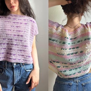 May include: Crocheted top in shades of lavender and purple, with a horizontal striped pattern. The top has short sleeves and a round neckline. The text "AUTUMN OLIVE" and "autumnolive.com" is visible on the left side of the image.