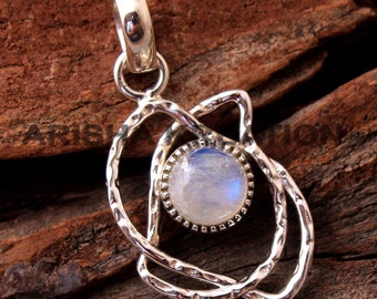 May include: A silver pendant with a round moonstone set in a delicate, twisted silver frame. The pendant has a bail for attaching to a chain.