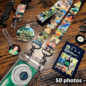 May include: A collection of custom lanyards and keychains featuring photo collages, including a round keychain with the text Take a Vacation, money returns, time does not, a black 8-ball keychain, and a clear plastic pouch with a camera graphic.