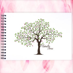 May include: A white notebook with a spiral binding on the left side. The notebook has a drawing of a green tree with pink flowers and the text "Family Tree" written below the tree.