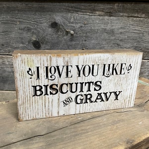Rustic and distressed farmhouse custom carved and painted &quot;I love you like biscuits and gravy&quot; wooden block sign or wall hanging.