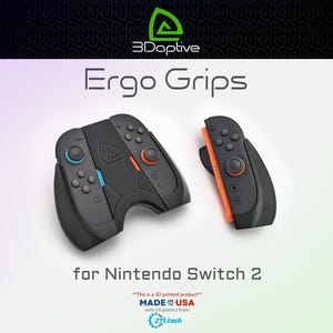 May include: Black Ergo Grips for Nintendo Switch 2. The grips have blue and orange accents. The image also includes the text "Ergo Grips" and "for Nintendo Switch 2". The product is 3D printed in the USA.