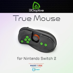 May include: A black and grey True Mouse controller for Nintendo Switch 2. The controller features green buttons and an orange centre button. The product is 3D printed and made in the USA.