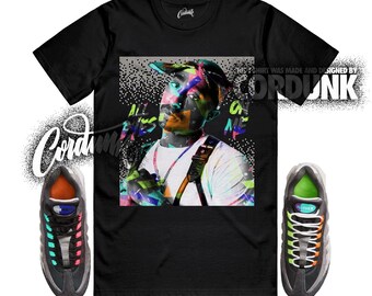 Peut inclure: T-shirt noir avec un graphisme coloré d'une personne et le texte "ALL EYES ON ME". L'image comprend également une paire de baskets noires et grises avec des accents colorés. Le t-shirt est fabriqué et conçu par Cordunk.