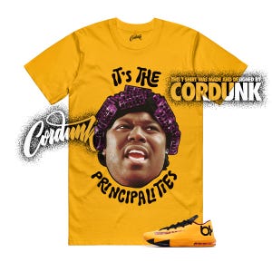 May include: Mustard yellow t-shirt with a graphic of a person wearing a purple hair curler and the text "IT'S THE PRINCIPALITIES". The shirt also has the text "CORDUNK" and a pair of orange and black sneakers.