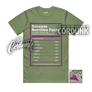 May include: Olive green t-shirt featuring a graphic of a nutrition facts label with the text "Success Nutrition Facts." The label lists "Hustle," "Patience," "Persistence," "Ambition," "Discipline," "Passion," and "Grind" as ingredients.
