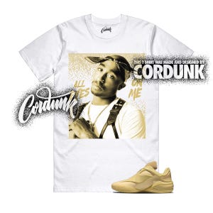 May include: White t-shirt featuring a sepia-toned image of a person wearing a bandana, with the text "ALL EYES ON ME." The shirt also has the text "THIS T SHIRT WAS MADE AND DESIGNED BY CORDUNK." A pair of tan sneakers is at the bottom.