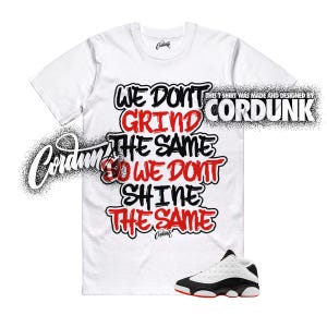 May include: White t-shirt with the text "WE DON'T GRIND THE SAME SO WE DON'T SHINE THE SAME" in black and red. A pair of black and white sneakers with red accents is at the bottom. The shirt is designed by Cordunk.