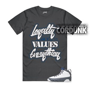 May include: Dark gray t-shirt with the words "Loyalty Out Values Everything" in white and blue lettering. A pair of white, gray, and blue sneakers are at the bottom of the image. The text "THIS T SHIRT WAS MADE AND DESIGNED BY CORDUNK" is on the right.