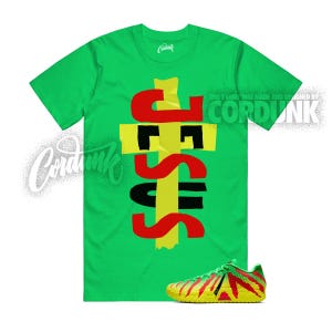 May include: A green t-shirt with the word "JESUS" in red, black, and yellow, and a pair of matching sneakers. The text "THIS T-SHIRT WAS MADE AND DESIGNED BY CORDUNK" is printed on the shirt.