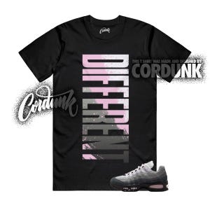 May include: Black t-shirt with the word "DIFFERENT" in vertical pink and gray letters. The shirt is paired with gray and black sneakers with pink accents. The Cordunk logo is visible.