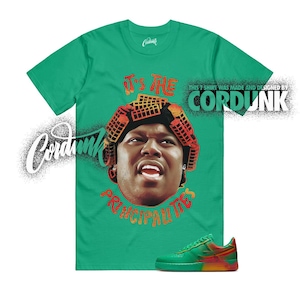 May include: Green t-shirt with a graphic of a person wearing curlers and the text "IT'S THE PRINCIPAL TIES". A pair of green, red, and yellow sneakers are at the bottom. The brand name "Cordunk" is also visible.