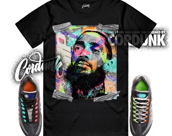 Peut inclure: T-shirt noir avec un portrait graphique coloré. Le t-shirt affiche le texte "CORDUNK" et "THIS SHIRT WAS MADE AND DESIGNED BY CORDUNK". Deux baskets noires et grises avec des détails colorés sont de chaque côté.