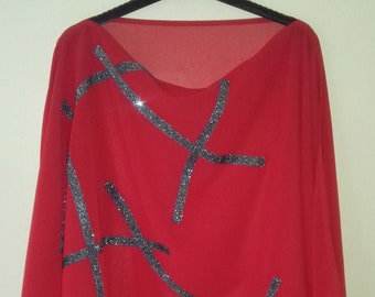 A red chiffon oversized cape top, with sparkle glitter trim details.