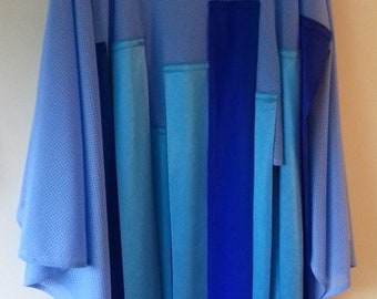 A blue mesh oversized cape top with tabs. One Size