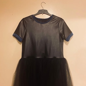 A black pleather top with dark blue trims and a black tulle skirt hem. Size Medium