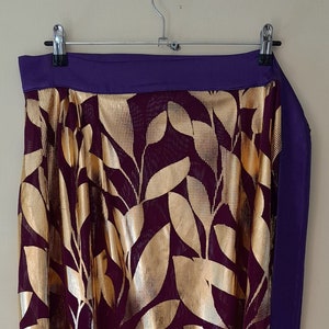 A fine burgundy with gold leaf print long wrap skirt, waist size 38 inches