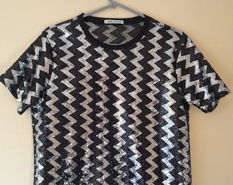 A black and silver full sequin t-shirt. Size Small