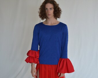 A blue floral embossed t-shirt with contrasting red ruffle sleeves. Size S/M