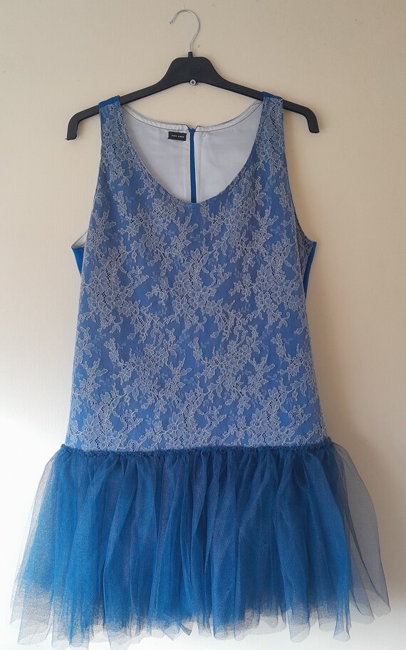 A Blue Vest Top With Grey Lace Overlay and a Navy Tulle Skirt Hem