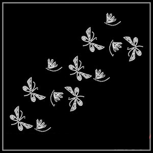 May include: A black background with a design of white, sparkling, rhinestone dragonflies scattered across the surface.