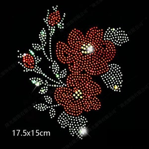 May include: Red and white rhinestone flower applique, measuring 17.5 cm by 15 cm. The applique features a cluster of flowers with leaves and stems.