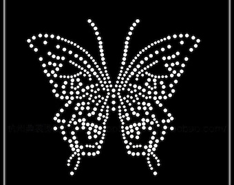 May include: A white rhinestone butterfly design on a black background. The butterfly is made of numerous small, round rhinestones. The dimensions are 16 x 15 cm, or approximately 6.3 x 5.9 inches.