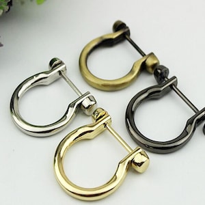 May include: Three metal D-ring clasps in gold, silver, and black.