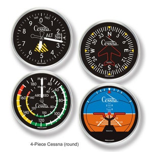 May include: Set of four round Cessna aircraft instrument gauges. The gauges are black with white and yellow markings. The gauges include an altimeter, compass, airspeed indicator, and a landing attitude indicator.